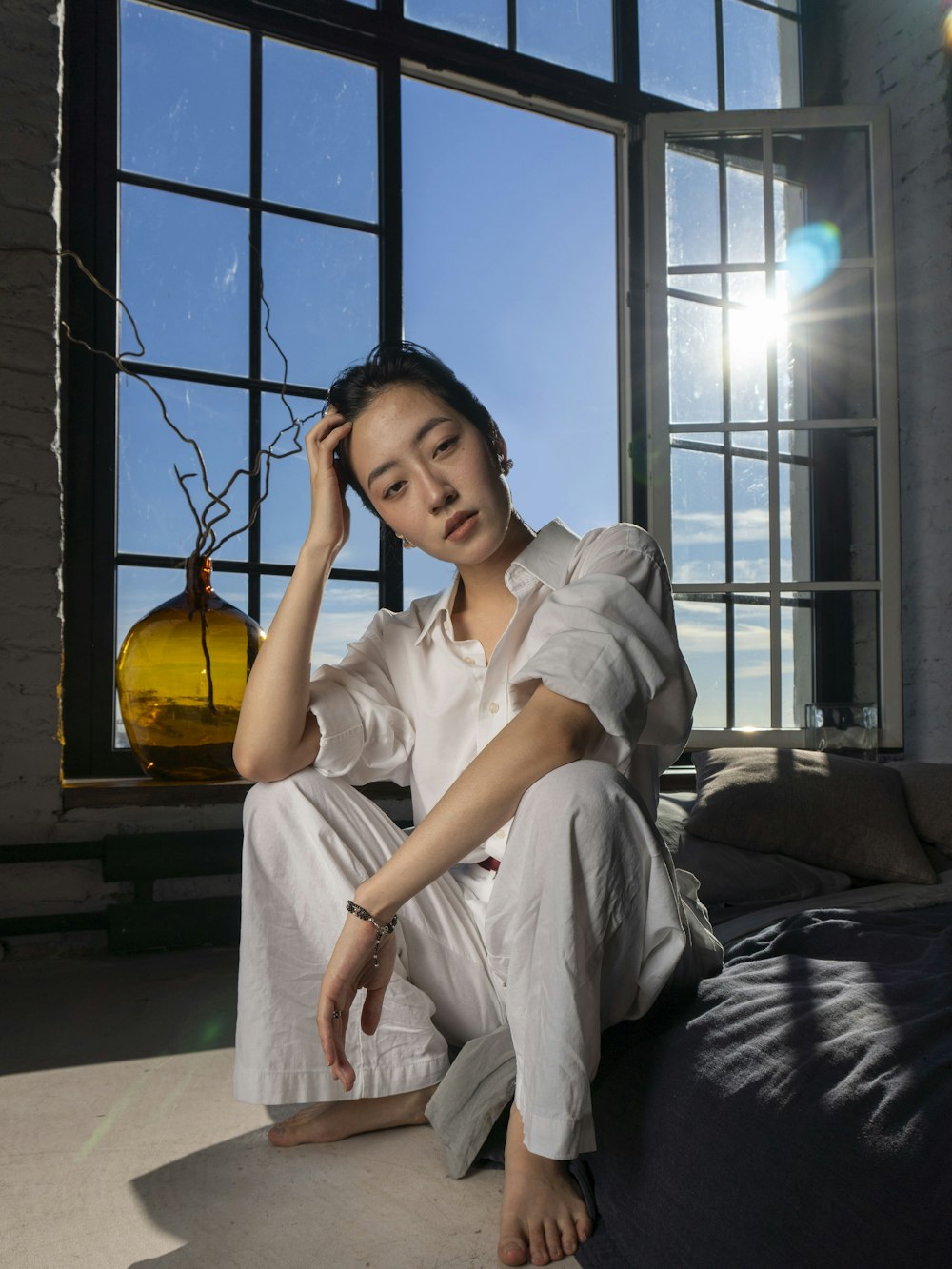 A yoga teacher in soft window light, face turned towards the window
