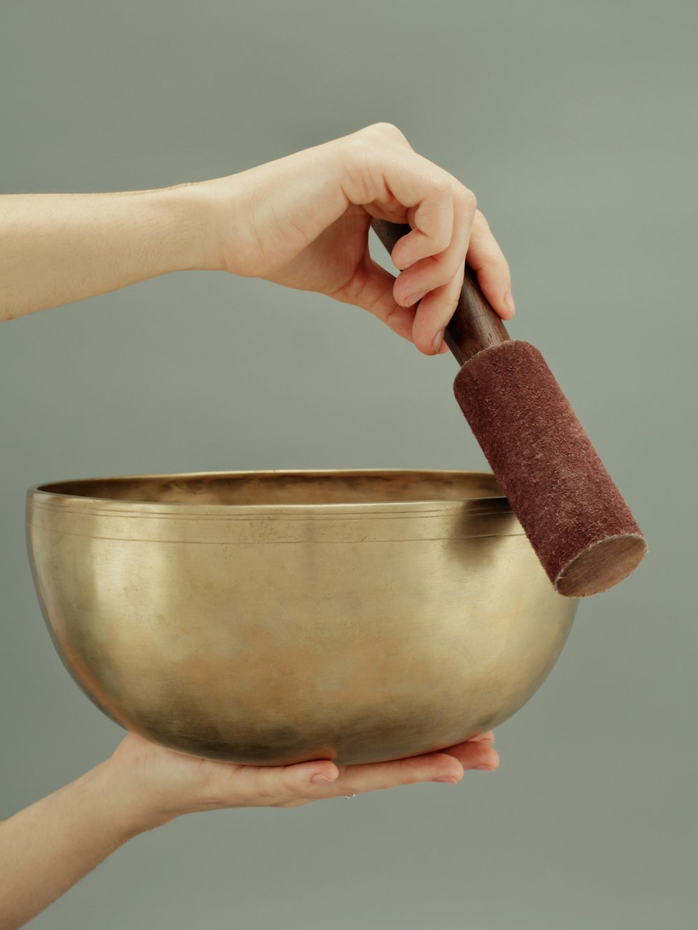Close view of a teacher's hands holding a singing bowl