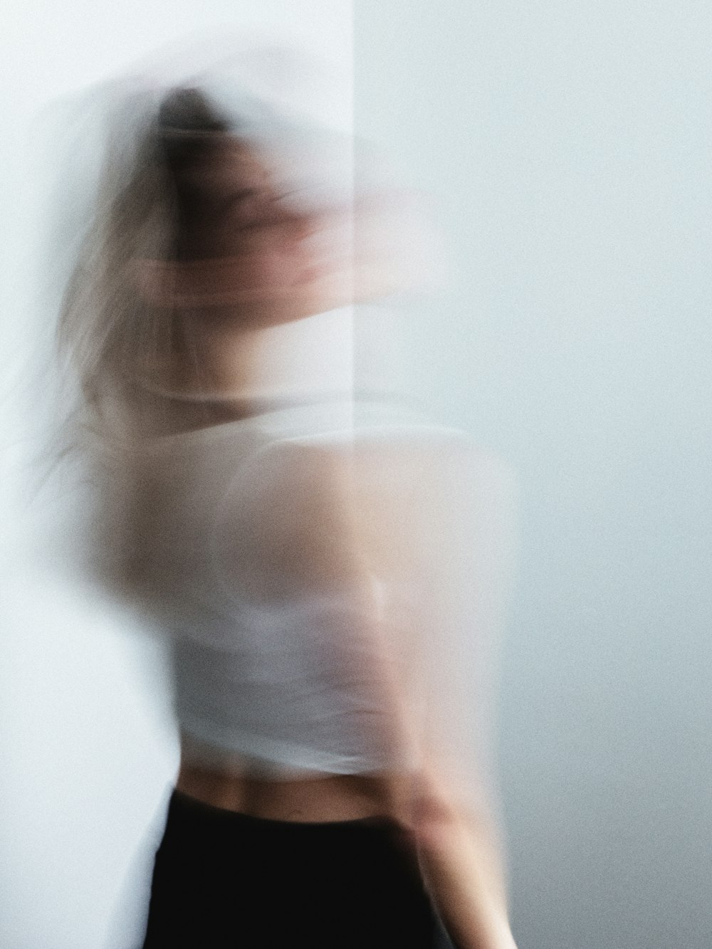 A student moving through a flowing sequence, softly blurred in daylight